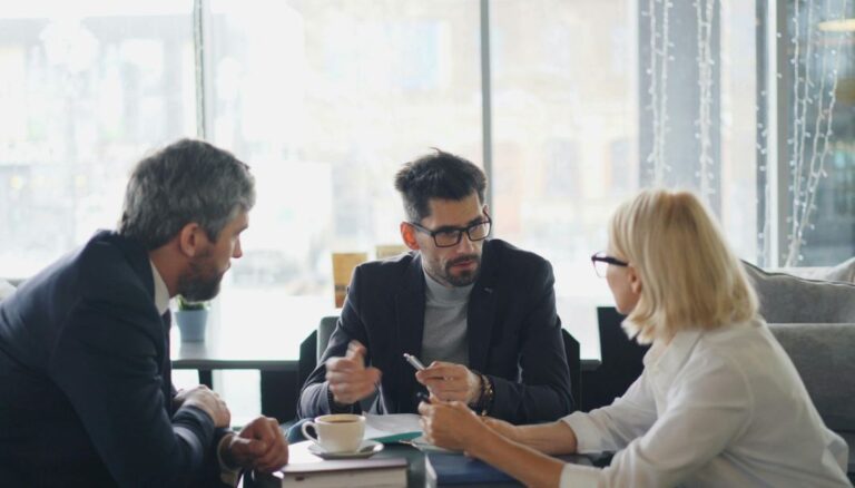 Recruiting leaders discussing strategic hiring partnership models in a modern workplace.