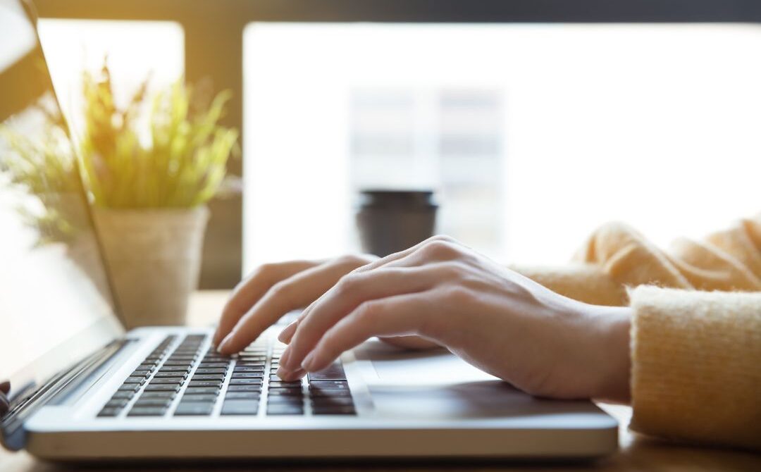 HR professional calculating benefits, payroll taxes, and overhead costs.