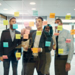 Leadership team at a high-growth technology company planning recruiting strategy for 2026 in a modern conference room.