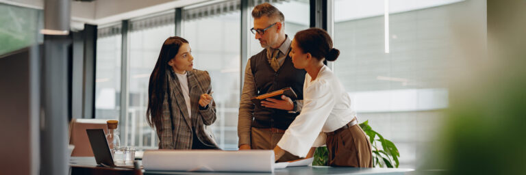 Leadership team evaluating talent acquisition models and recruiting strategy options