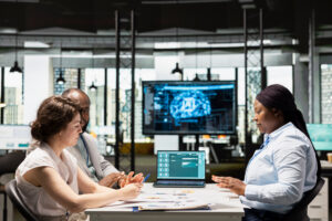 Professional recruiters reviewing candidate profiles during talent search meeting