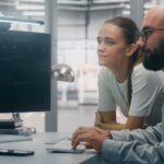 Technical professionals working across engineering and IT systems in a modern technology environment