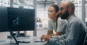 Technical professionals working across engineering and IT systems in a modern technology environment