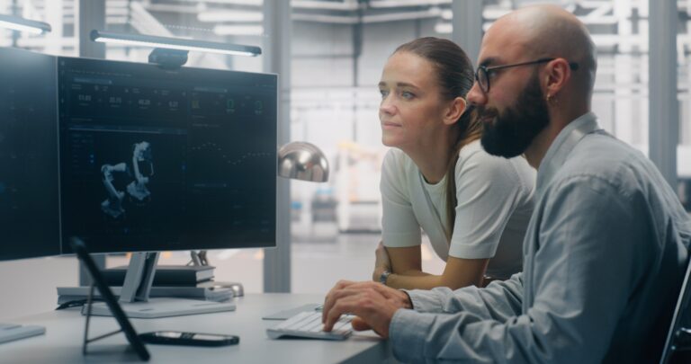 Technical professionals working across engineering and IT systems in a modern technology environment