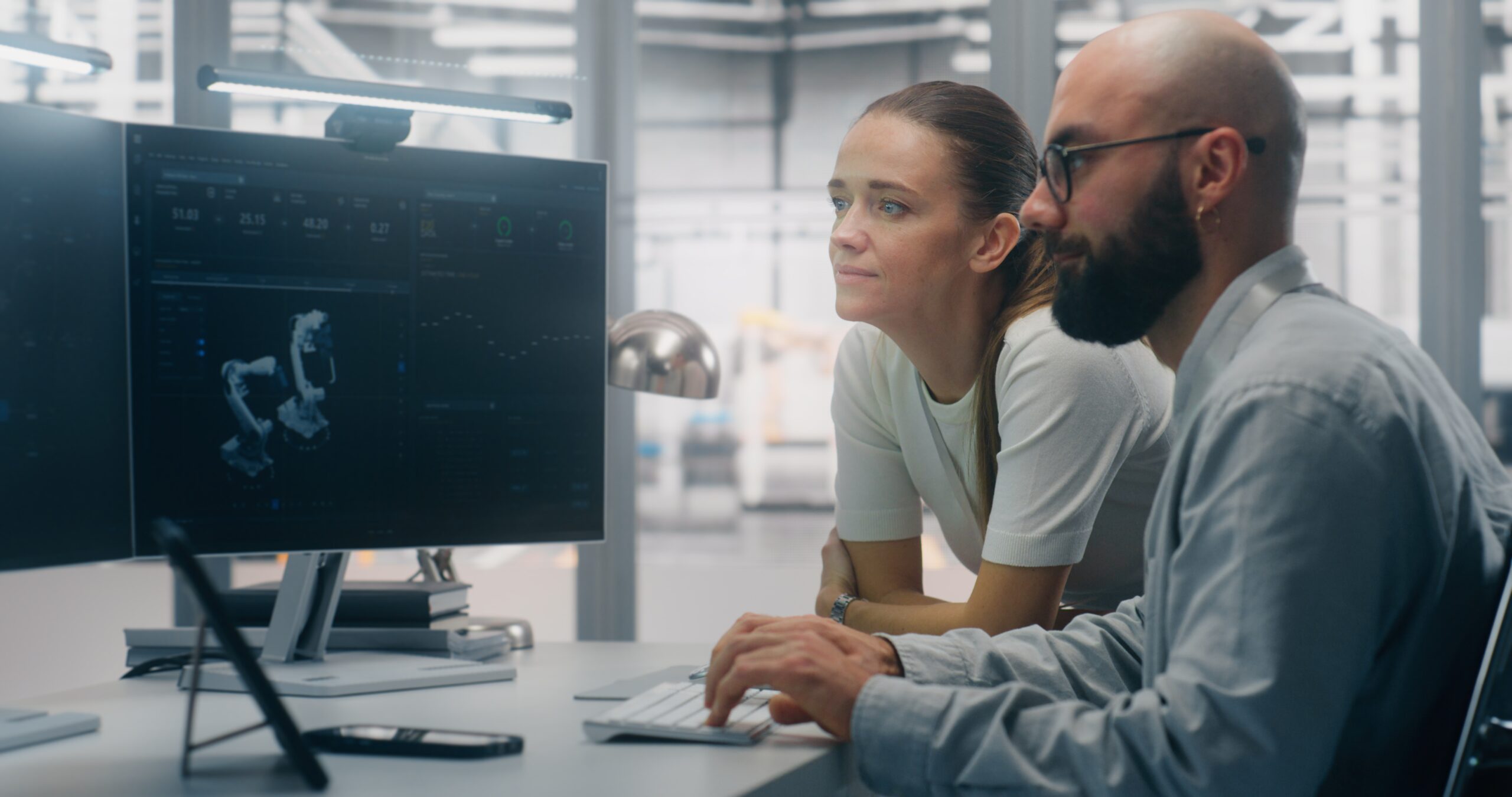 Technical professionals working across engineering and IT systems in a modern technology environment