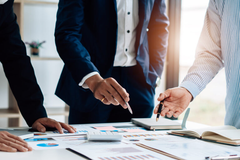 Executive leadership team reviewing a structured quarterly hiring plan during a strategy meeting.