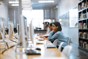University students participating in structured internship experience inside a professional office setting.